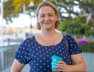 Woman holding Veolia Travel Mug