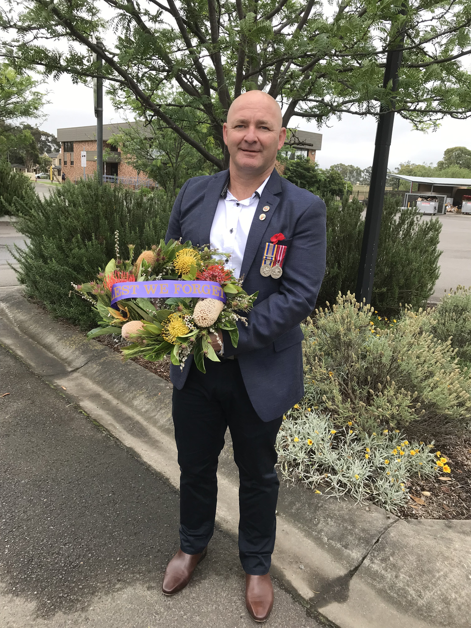 Veteran with lest we forget wreath