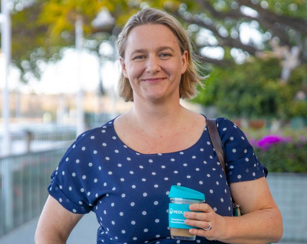 Woman holding Veolia Travel Mug