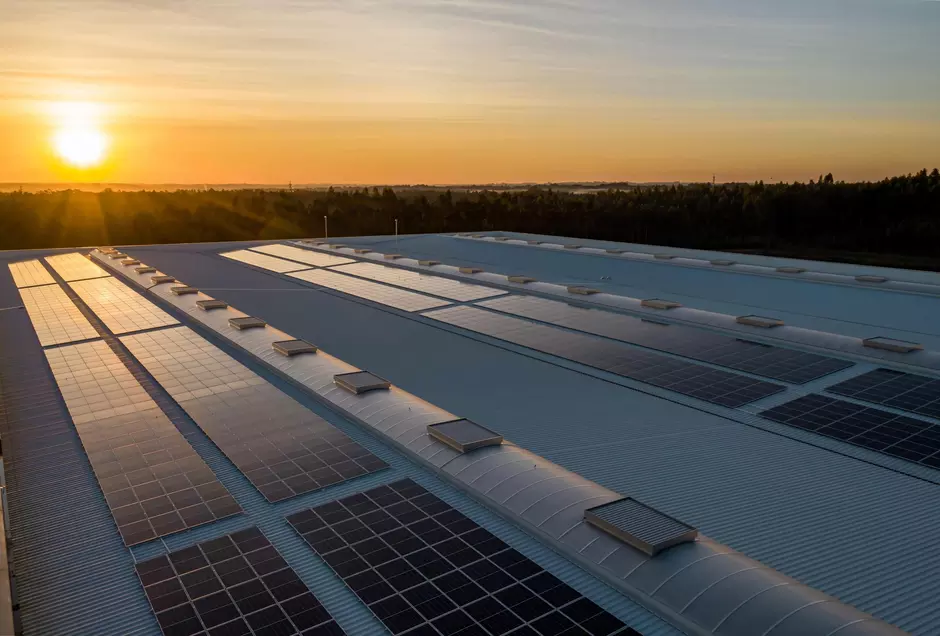 Solar panels on roof with strong sun in the background